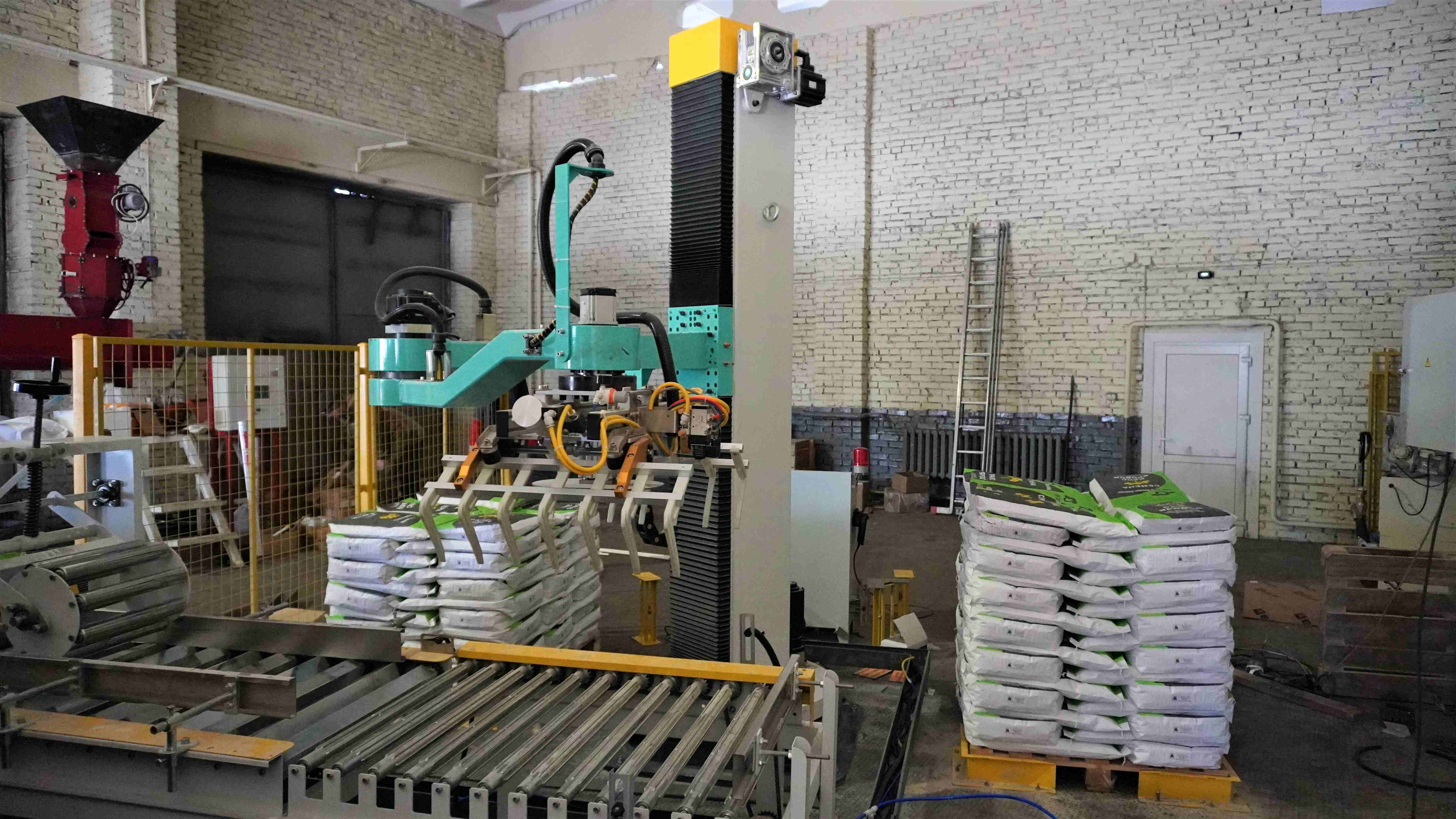 Bagging line with a robotic palletizer and conveyor system